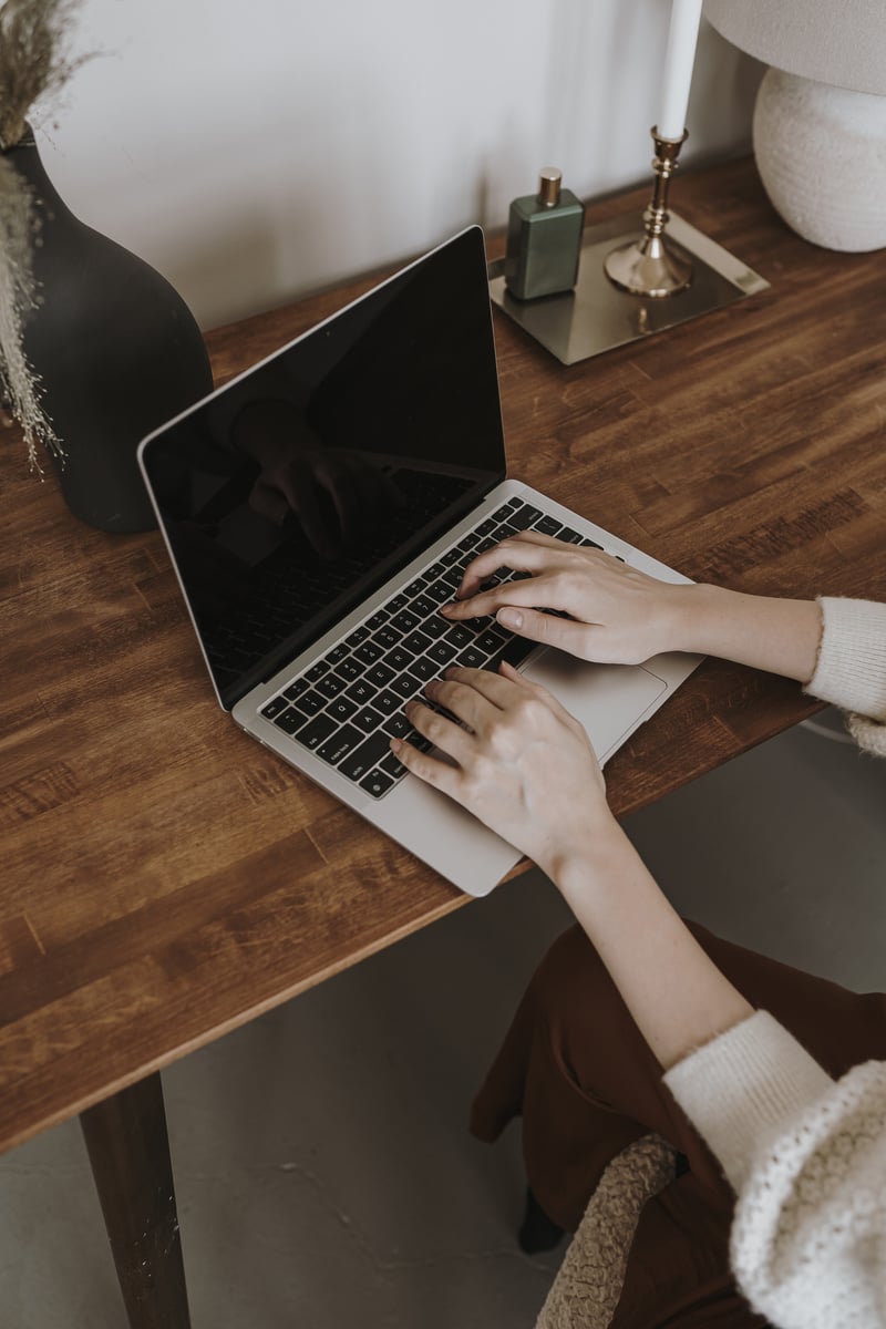 Woman Typing on Laptop